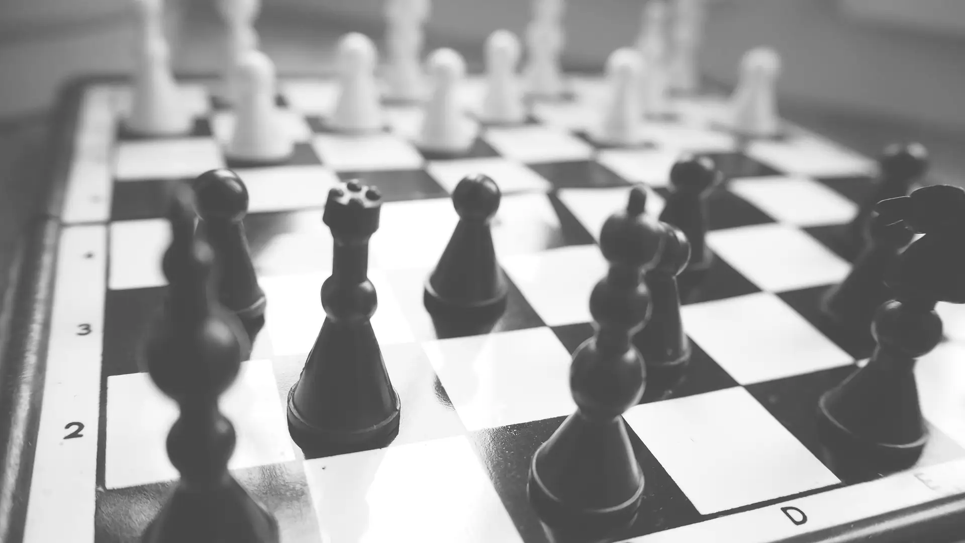 Black and white chess position viewed from board level
